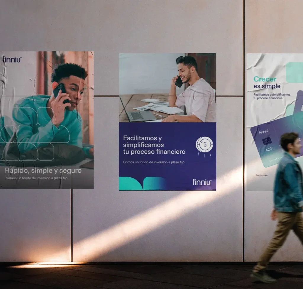 Proyecto para Finniu, fintech de inversión: afiches publicitarios con la identidad visual de la marca en una pared urbana
